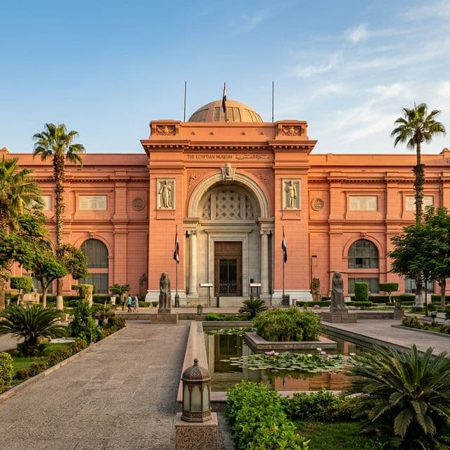 The grand neoclassical facade of the Egyptian Museum in Cairo surrounded by lush gardens